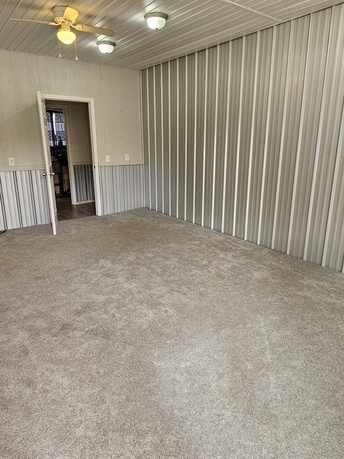 unfurnished room featuring carpet flooring and ceiling fan