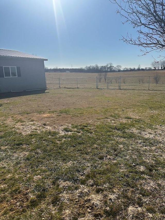 view of yard featuring a rural view and fence