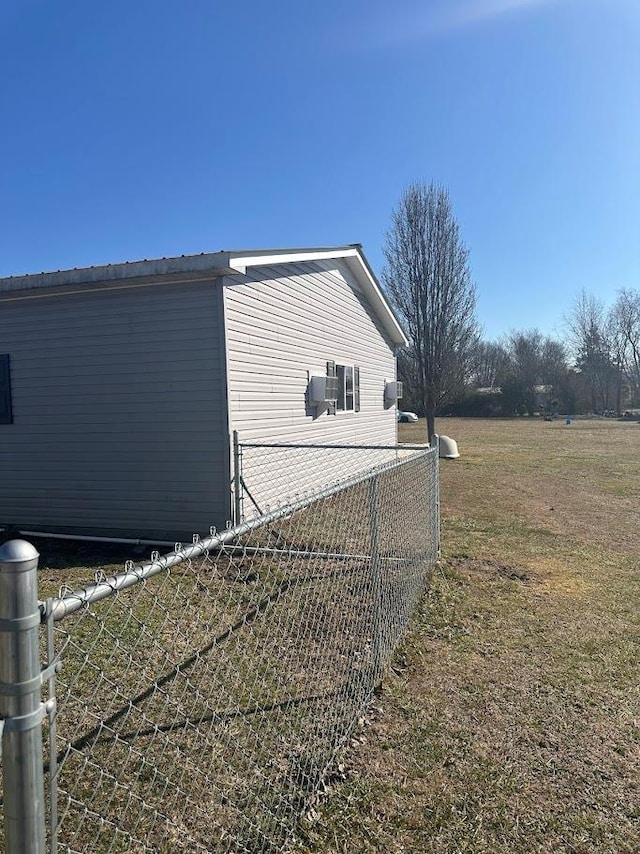 view of side of property featuring a yard and fence