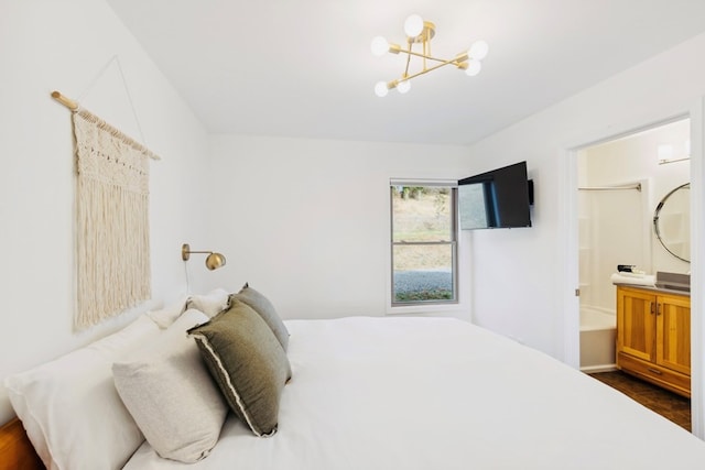 bedroom featuring a chandelier and ensuite bathroom