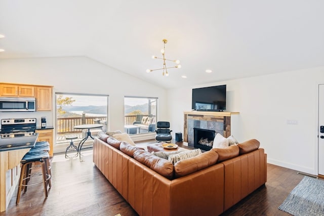 living area featuring dark wood-style floors, recessed lighting, a fireplace, lofted ceiling, and a chandelier