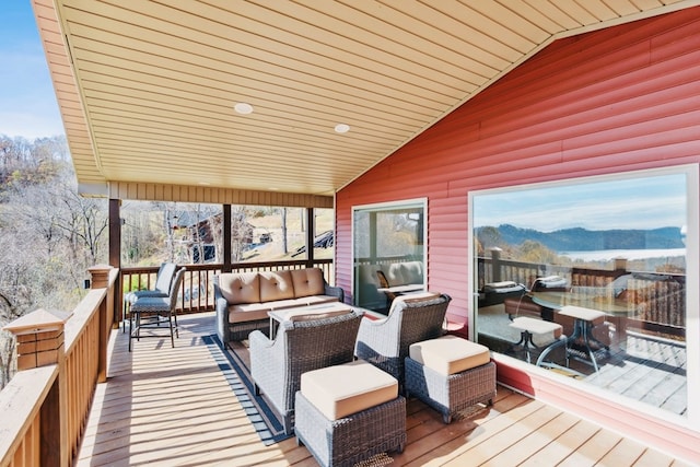 wooden deck featuring a mountain view and outdoor lounge area