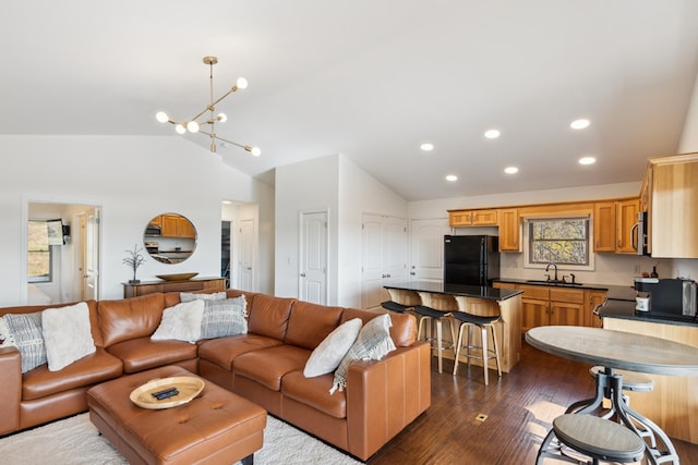 living room with vaulted ceiling, a notable chandelier, recessed lighting, and dark wood-style flooring