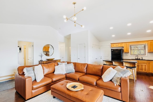 living room with recessed lighting, lofted ceiling, an inviting chandelier, and dark wood-style flooring