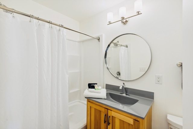 bathroom featuring curtained shower, toilet, and vanity