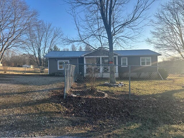 view of front of home featuring a fenced front yard and metal roof