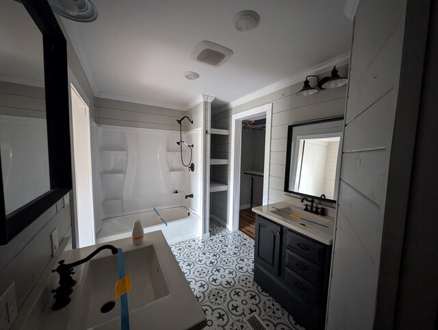 bathroom featuring ornamental molding,  shower combination, a closet, and vanity