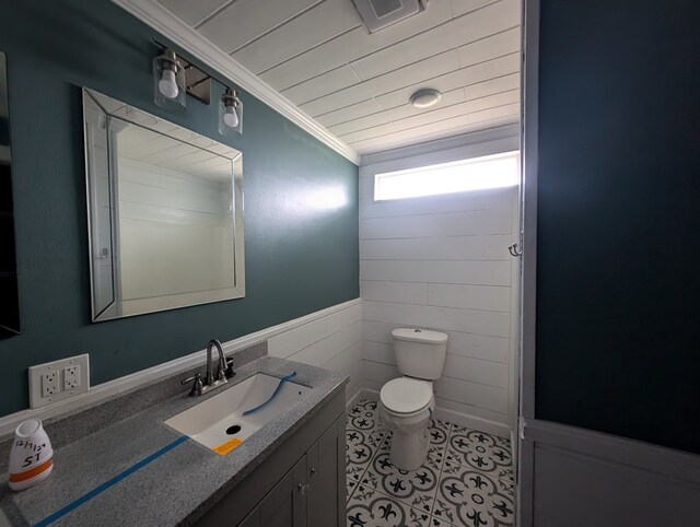 bathroom featuring toilet, visible vents, vanity, tile patterned floors, and crown molding