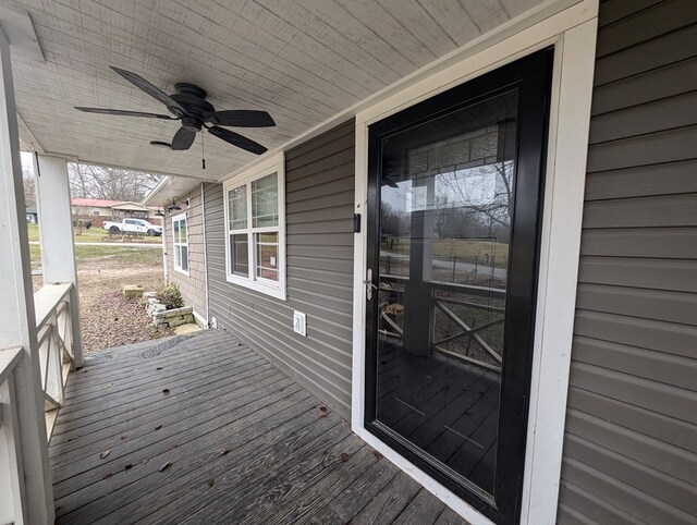 wooden deck with a porch and a ceiling fan