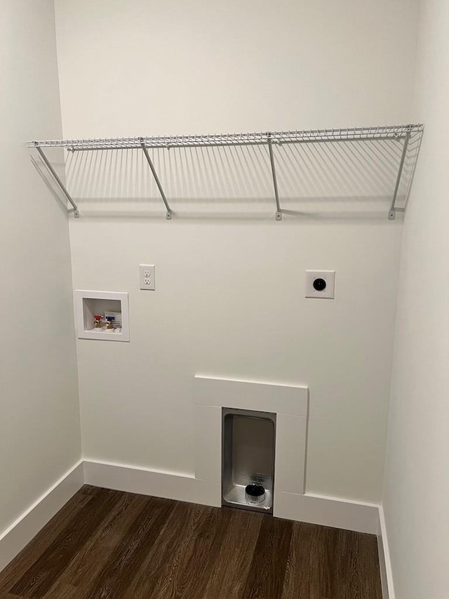 laundry area with laundry area, baseboards, dark wood-style flooring, hookup for a washing machine, and electric dryer hookup