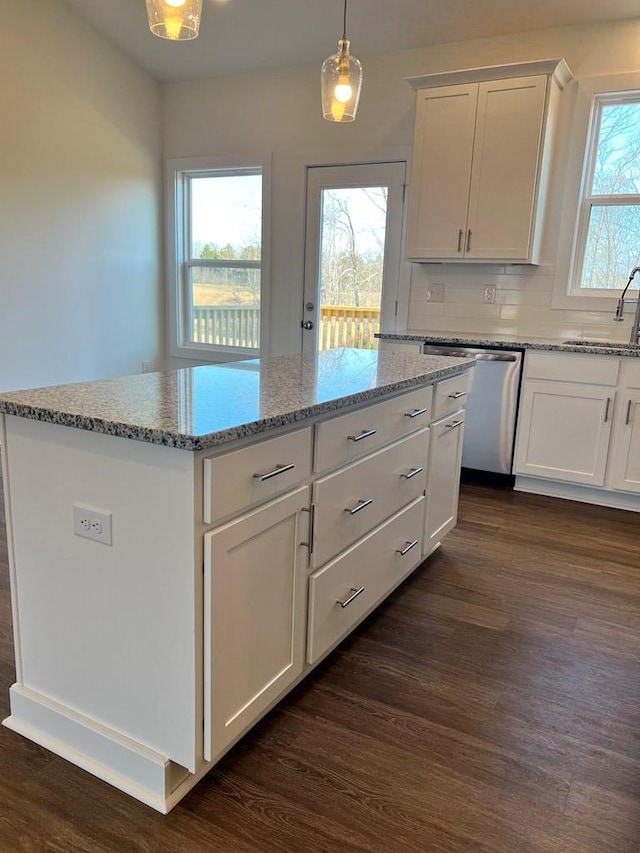 kitchen featuring dishwasher, a kitchen island, dark wood-type flooring, white cabinetry, and pendant lighting