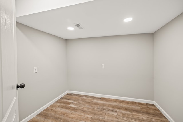 spare room with recessed lighting, wood finished floors, visible vents, and baseboards