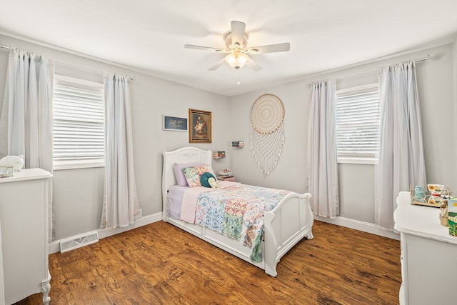 bedroom featuring ceiling fan, dark wood-type flooring, multiple windows, and visible vents