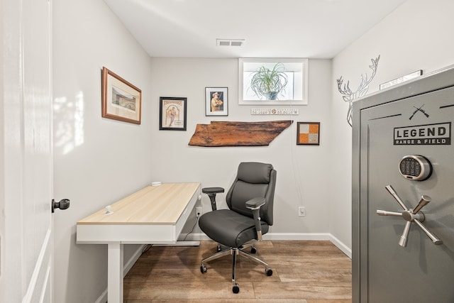 office space featuring visible vents, baseboards, and wood finished floors