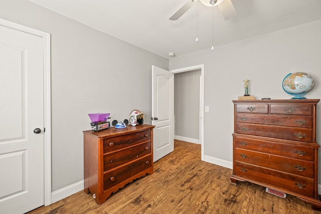 bedroom featuring a ceiling fan, baseboards, and wood finished floors