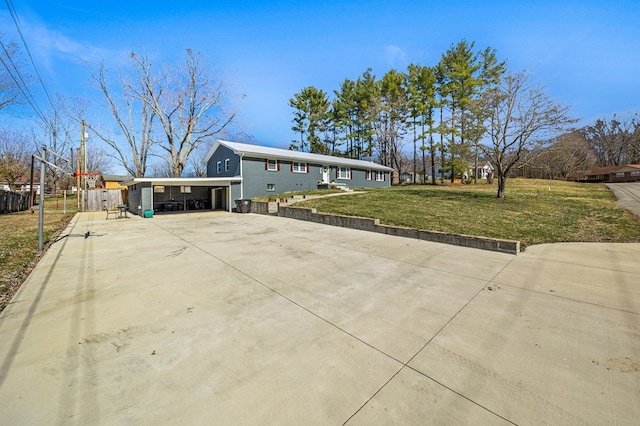 view of front facade featuring concrete driveway and a front yard