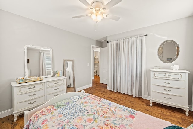 bedroom with dark wood-style floors, ceiling fan, and baseboards