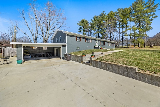 exterior space featuring concrete driveway, a front lawn, and brick siding