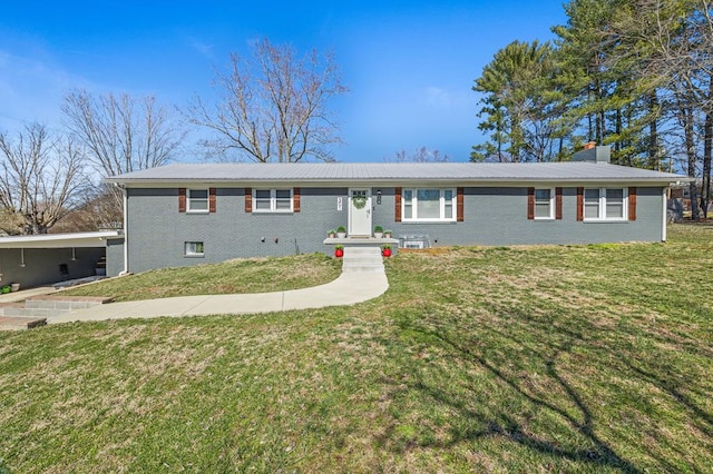 ranch-style house with a front yard, brick siding, and a chimney