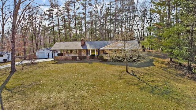 ranch-style house featuring a porch, a chimney, and a front lawn