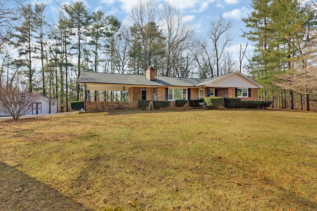 single story home featuring a front yard, a chimney, brick siding, and an attached carport