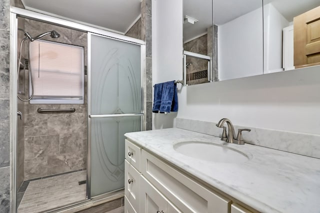 full bathroom featuring a stall shower and vanity