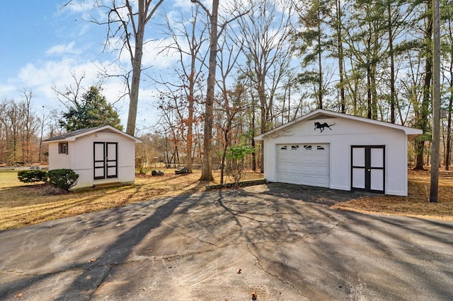 detached garage featuring driveway