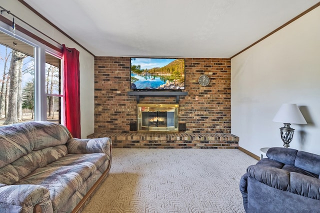 carpeted living area featuring baseboards, a brick fireplace, and crown molding