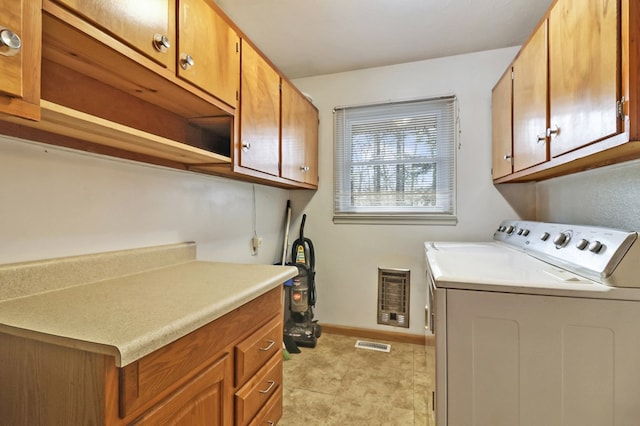 laundry area featuring washer and dryer, cabinet space, visible vents, and baseboards