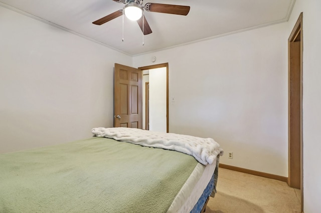 bedroom with light carpet, crown molding, baseboards, and ceiling fan