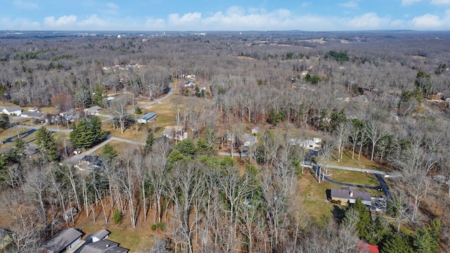 birds eye view of property with a wooded view