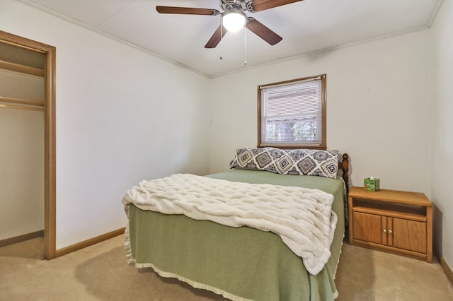 bedroom with baseboards, ornamental molding, a ceiling fan, and light colored carpet