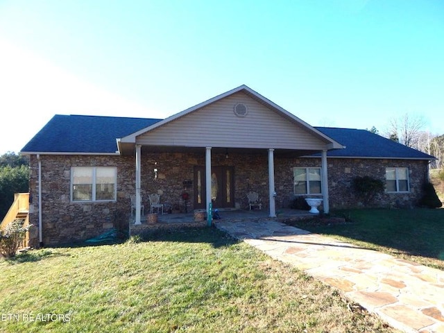 ranch-style house with stone siding and a front yard