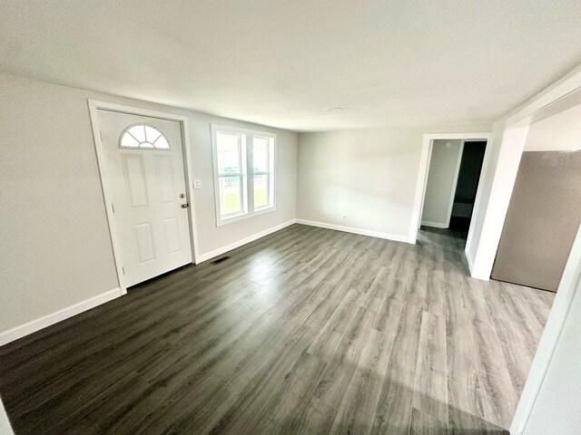 entryway with visible vents, light wood-style flooring, and baseboards