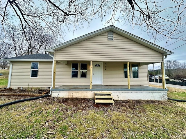 view of front of home featuring crawl space, covered porch, a front lawn, and roof with shingles