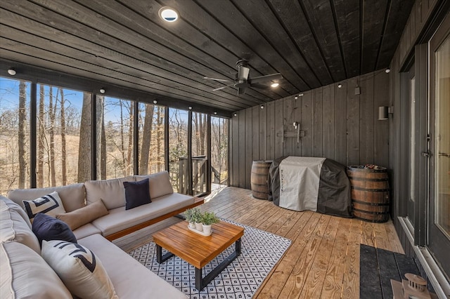 sunroom featuring wood ceiling and ceiling fan