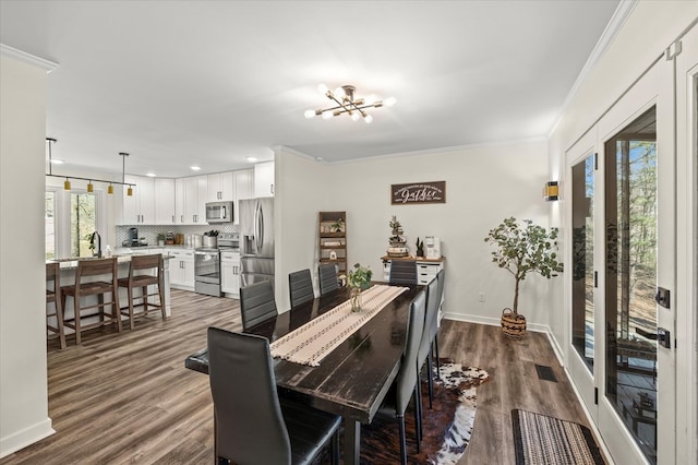 dining room featuring ornamental molding, visible vents, baseboards, and dark wood-style floors