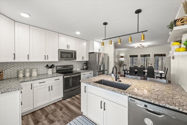 kitchen featuring stainless steel appliances, dark wood-style flooring, a sink, and white cabinetry