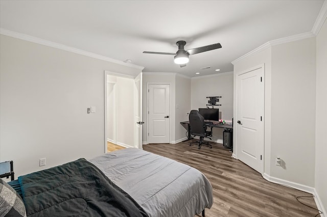 bedroom featuring a ceiling fan, crown molding, baseboards, and wood finished floors