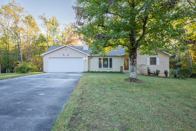 single story home with a garage, brick siding, driveway, a front lawn, and a chimney