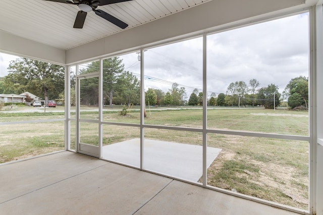 unfurnished sunroom with a ceiling fan