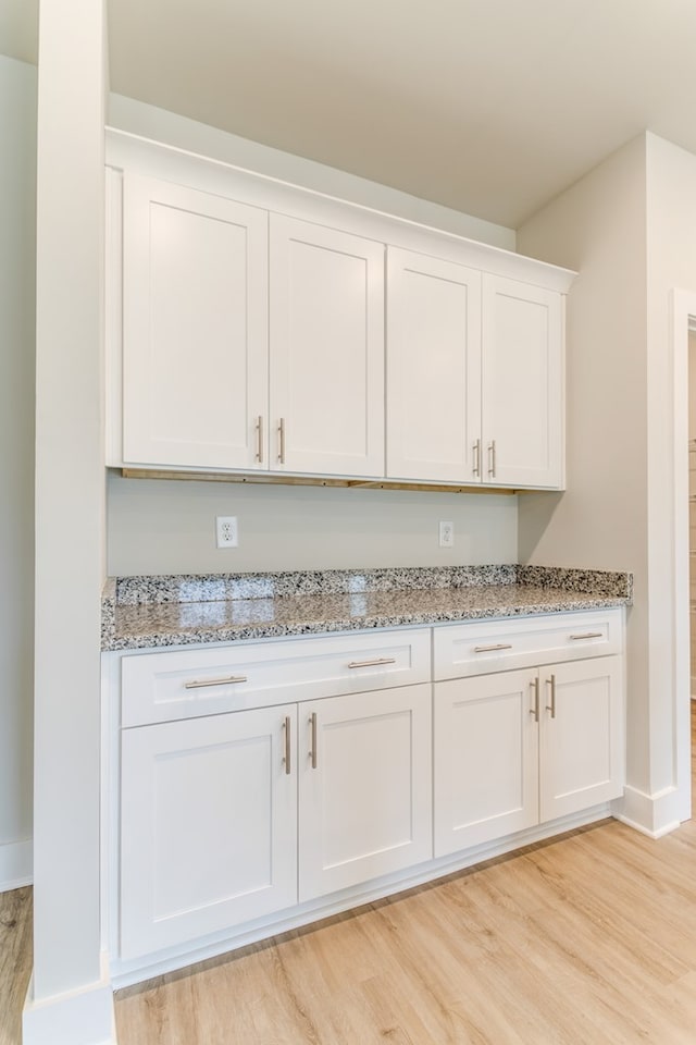 room details featuring baseboards and wood finished floors