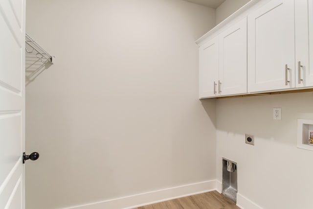 clothes washing area with washer hookup, light wood finished floors, cabinet space, hookup for an electric dryer, and baseboards