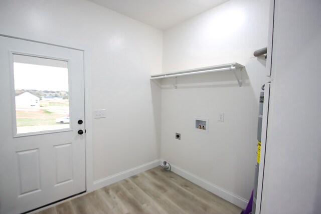 laundry area with light wood-style flooring, hookup for an electric dryer, laundry area, washer hookup, and baseboards