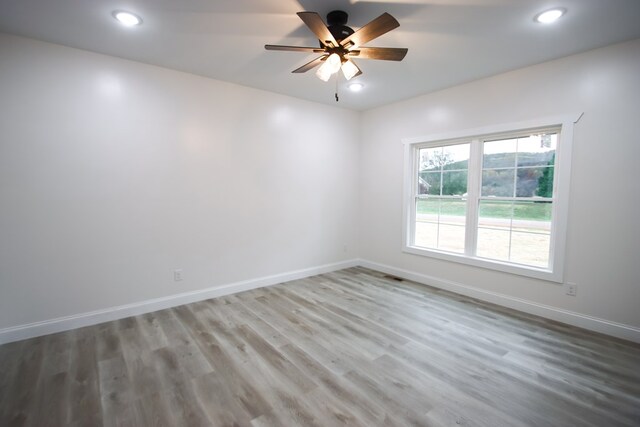 spare room with recessed lighting, visible vents, ceiling fan, wood finished floors, and baseboards