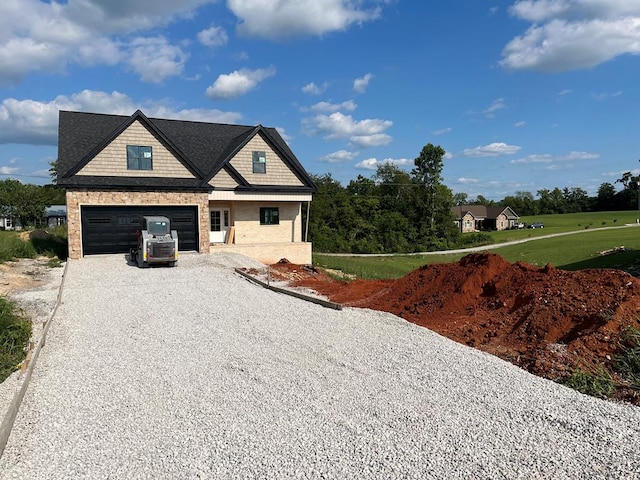 view of front of house featuring a garage and gravel driveway