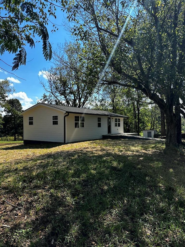 rear view of property featuring a lawn