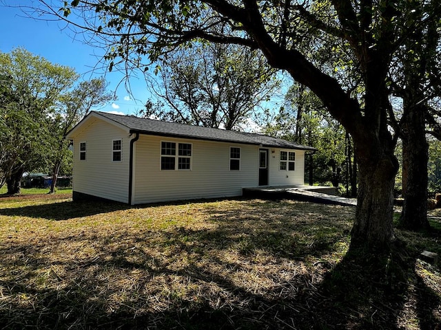 back of property featuring a lawn