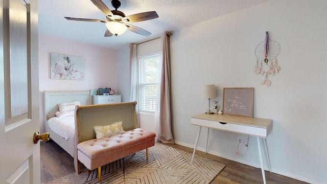 bedroom featuring a ceiling fan, dark wood finished floors, a textured ceiling, and baseboards