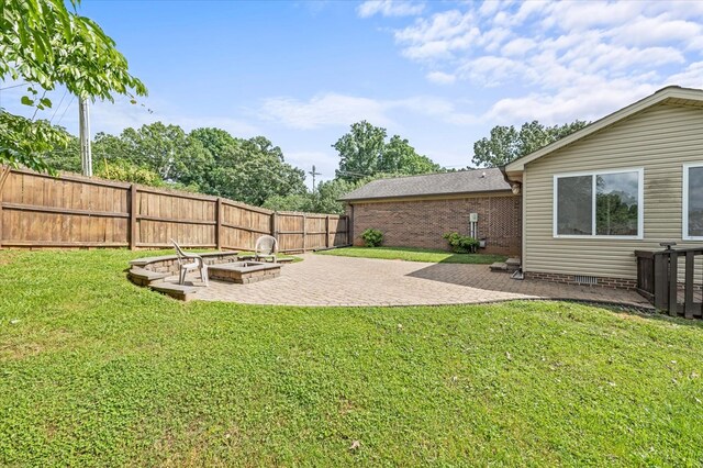 view of yard featuring a patio area, a fenced backyard, and a vegetable garden